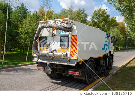 Municipal sweeper cleaning city street. Industrial truck equipment for road sanitation and waste collection. Urban hygiene maintenance vehicle working on road. Public service machine. Municipal sweeper cleaning city street. Industrial truck equipment for road sanitation and waste collection. Urban hygiene maintenance vehicle working on road. Public service machine. 138125710