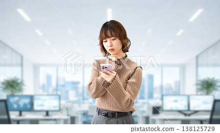 A woman/businesswoman thinking while looking at her smartphone A woman/businesswoman thinking while looking at her smartphone 138125729