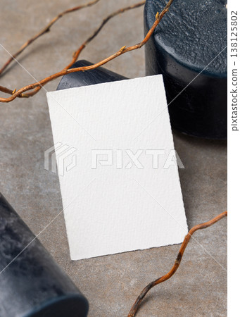 Blank card mockup on grey stone with dry branches and candles. Minimal stationery template 138125802