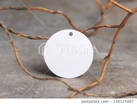 Blank round gift tag mockup on grey stone with dry branches, copy space. Handmade product label Blank round gift tag mockup on grey stone with dry branches, copy space. Handmade product label 138125807