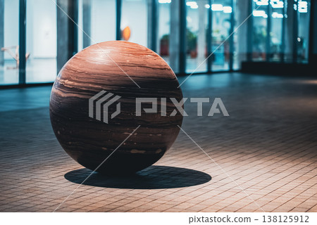 Large stone sphere sculpture in modern urban space with minimal design, Polished marble ball installation with texture and geometric form in contemporary plaza setting Large stone sphere sculpture in modern urban space with minimal design, Polished marble ball installation with texture and geometric form in contemporary plaza setting 138125912