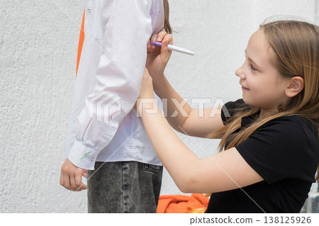 Cheerful girl with a colour pencil in school Cheerful girl with a colour pencil in school 138125926