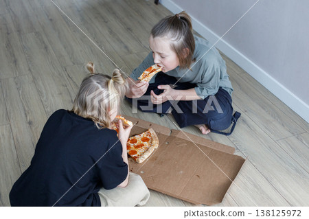Children kids sibling eating pizza at home. Little girl and boy children portrait 138125972