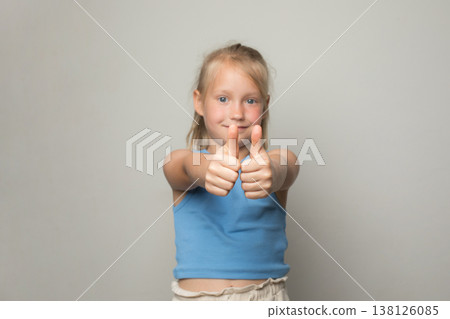 Hand with thumb up close up. Happy child showing thumb up Hand with thumb up close up. Happy child showing thumb up 138126085