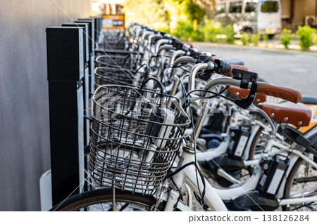 Electric-assist rental bicycles are neatly lined up at dedicated ports located throughout the city. Electric-assist rental bicycles are neatly lined up at dedicated ports located throughout the city. 138126284