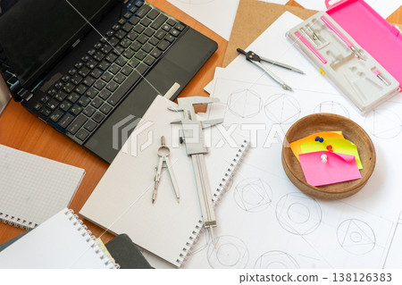 Engineer Workspace Laptop, Technical Drawings, Vernier Caliper, Compasses and Stationery Tools Engineer Workspace Laptop, Technical Drawings, Vernier Caliper, Compasses and Stationery Tools 138126383