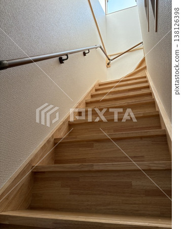 A bright indoor staircase with handrails installed - a residential renovation project image. A bright indoor staircase with handrails installed - a residential renovation project image. 138126398