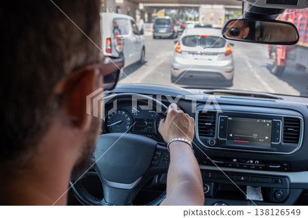 Driving in Busy City Traffic During the Day With Modern Cars and Urban Structures in the Background 138126549