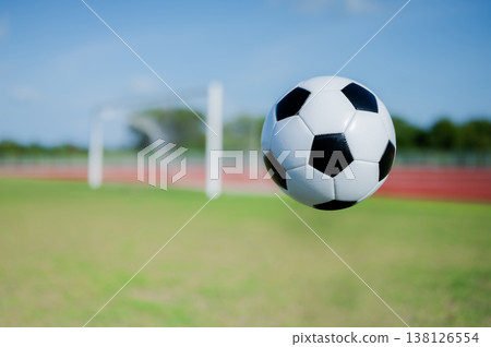 Footballs on the field and goal nets in a large stadium 138126554