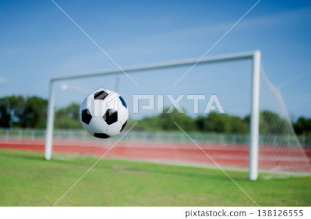 Footballs on the field and goal nets in a large stadium 138126555