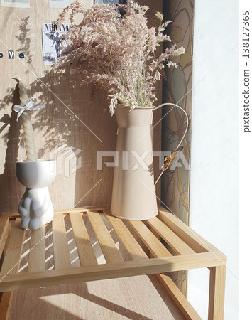 Aesthetic still life in Scandinavian style: a decorative candle in a white candlestick 138127365