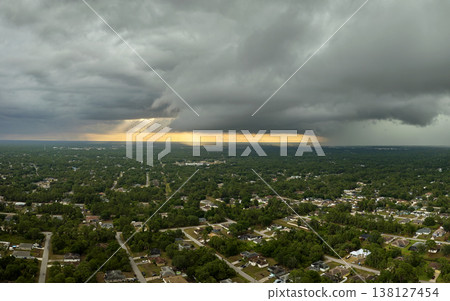 Landscape of dark ominous clouds forming on stormy sky before heavy thunderstorm over rural town area Landscape of dark ominous clouds forming on stormy sky before heavy thunderstorm over rural town area 138127454