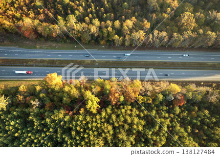 Highway road in North Carolina Appalachian mountains in fall season. Expressway lanes for fast passing of car traffic Highway road in North Carolina Appalachian mountains in fall season. Expressway lanes for fast passing of car traffic 138127484