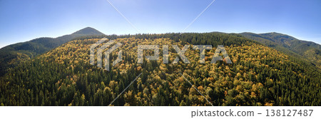 High hills with dark pine woods on autumn bright day. Amazing scenery of wild mountain woodland High hills with dark pine woods on autumn bright day. Amazing scenery of wild mountain woodland 138127487