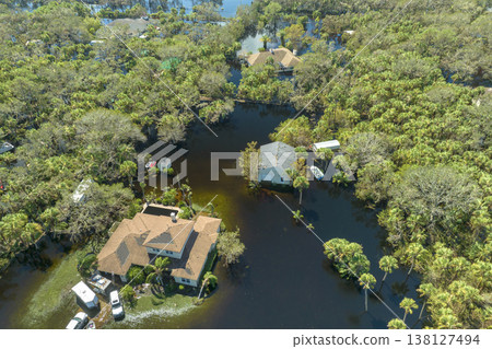Heavy flood with high water surrounding residential houses after hurricane Ian rainfall in Florida residential area. Consequences of natural disaster Heavy flood with high water surrounding residential houses after hurricane Ian rainfall in Florida residential area. Consequences of natural disaster 138127494