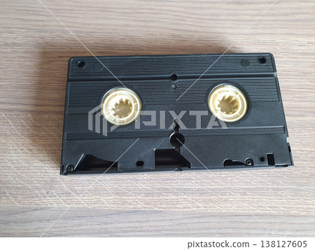 Black retro VHS video cassette lying on a wooden surface Black retro VHS video cassette lying on a wooden surface 138127605