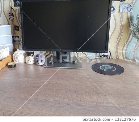 Modern workplace: open notebook, headphones in case and monitor on wooden table. Bright interior for studying, remote work and creative planning. 138127670