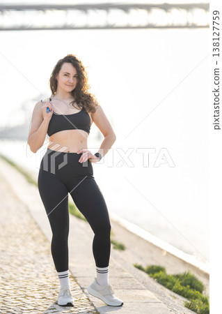 Young woman preparing for fitness training with jump rope 138127759