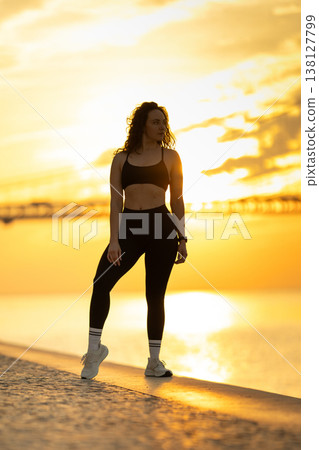 Woman exercising outdoors at golden hour sunset Woman exercising outdoors at golden hour sunset 138127799