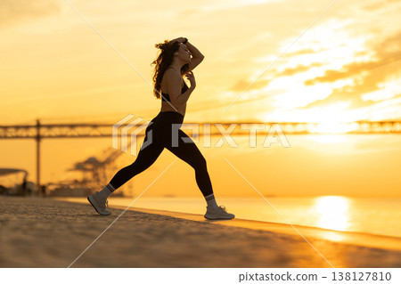 Woman exercising outdoors at sunset enjoying fitness lifestyle 138127810
