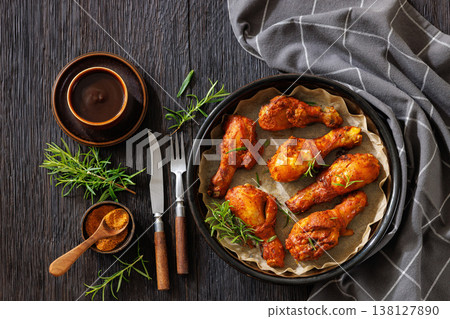 Roasted chicken drumsticks on paper in baking dish Roasted chicken drumsticks on paper in baking dish 138127890