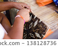 Hands of Indigenous Mangyan Woman Carefully Weaving a Traditional Basket from Bamboo Fibers in Mangyan Village, Talipanan, Puerto Galera, Oriental Mindoro, Philippines 138128736