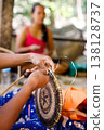 Hands of Indigenous Mangyan Woman Carefully Weaving a Traditional Basket from Bamboo Fibers in Mangyan Village, Talipanan, Puerto Galera, Oriental Mindoro, Philippines 138128737