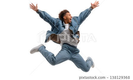 A joyful person doing a small jump with arms raised, smiling brightly. Isolated on white background. 138129368