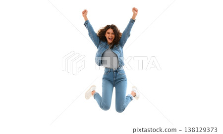 A joyful person doing a small jump with arms raised, smiling brightly. Isolated on white background. 138129373