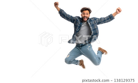 A joyful person doing a small jump with arms raised, smiling brightly. Isolated on white background. 138129375