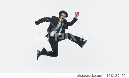 Businessman jumping with energetic pose isolated on white background studio shot. Businessman jumping with energetic pose isolated on white background studio shot. 138129451