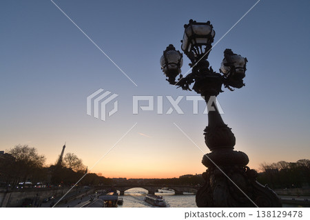 A view of the sunset and streetlights during magic hour from the Pont Alexandre III, Paris, March 18, 2026. 138129478