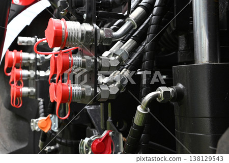 Close look at hydraulic connections on a tractor Close look at hydraulic connections on a tractor 138129543