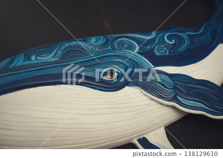 Close-up of a carved wooden whale showing intricate blue textures and an eye detail. Close-up of a carved wooden whale showing intricate blue textures and an eye detail. 138129610