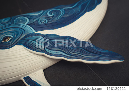 Close-up detail of a hand-painted wooden whale sculpture, focusing on the fin and intricate carved patterns. Close-up detail of a hand-painted wooden whale sculpture, focusing on the fin and intricate carved patterns. 138129611