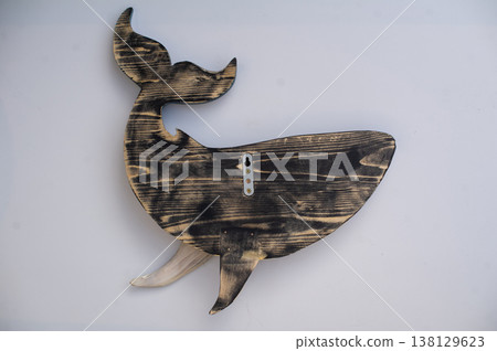 Back view of a hand-carved wooden whale sculpture, showing natural scorched wood grain and a metal mounting bracket. Back view of a hand-carved wooden whale sculpture, showing natural scorched wood grain and a metal mounting bracket. 138129623