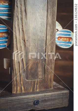 Close-up of a rustic wooden lamp base showing natural timber grain, carved recessed panel, and a power socket. Close-up of a rustic wooden lamp base showing natural timber grain, carved recessed panel, and a power socket. 138129632