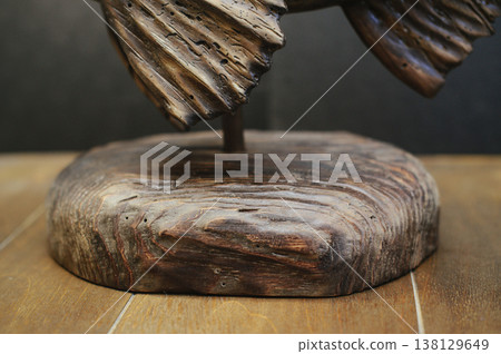 Macro shot of the solid timber base of a hand-carved fish sculpture, showcasing deep wood grain and weathered textures. Macro shot of the solid timber base of a hand-carved fish sculpture, showcasing deep wood grain and weathered textures. 138129649