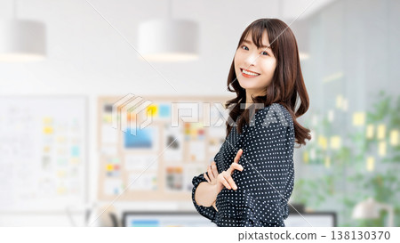 A smiling woman with her arms crossed - a businesswoman 138130370