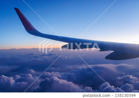 Sunset above the clouds from airplane Sunset above the clouds from airplane 138130394