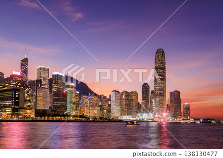 Hong Kong city skyline at sunset with glowing sky and skyscrapers Hong Kong city skyline at sunset with glowing sky and skyscrapers 138130477