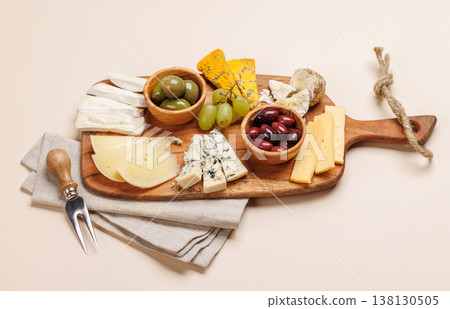 Cheese board with assorted cheeses and olives Cheese board with assorted cheeses and olives 138130505