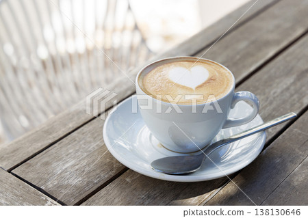 Cappuccino with heart foam on wooden table Cappuccino with heart foam on wooden table 138130646