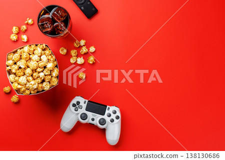 Popcorn, cola and gamepad on red background Popcorn, cola and gamepad on red background 138130686