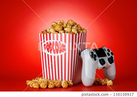 Popcorn and gamepad on red background 138130917