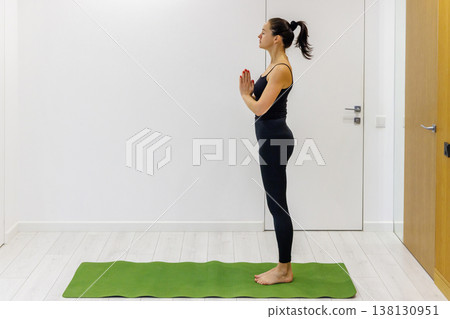 Woman practicing yoga at home Woman practicing yoga at home 138130951