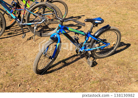Bicycles on a path in a public park. The concept of active outdoor play and cycling as a healthy lifestyle for recreation, 138130982