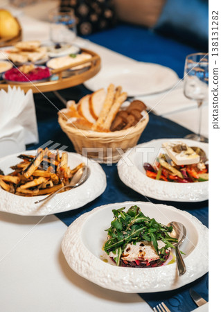 Group Meal Ambiance. Communal Dining Experience With Diverse Dishes And Cozy Lighting 138131282