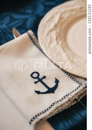 Seaside Dining Decor. Beachinspired Table Setup Featuring Anchor Motifs And Ocean Tones 138131285