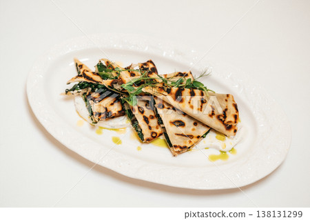 Herb Oil Flatbread. Charred Flatbread With Herbs. Grilled Flatbread Decorated With Herbs And Lemon 138131299